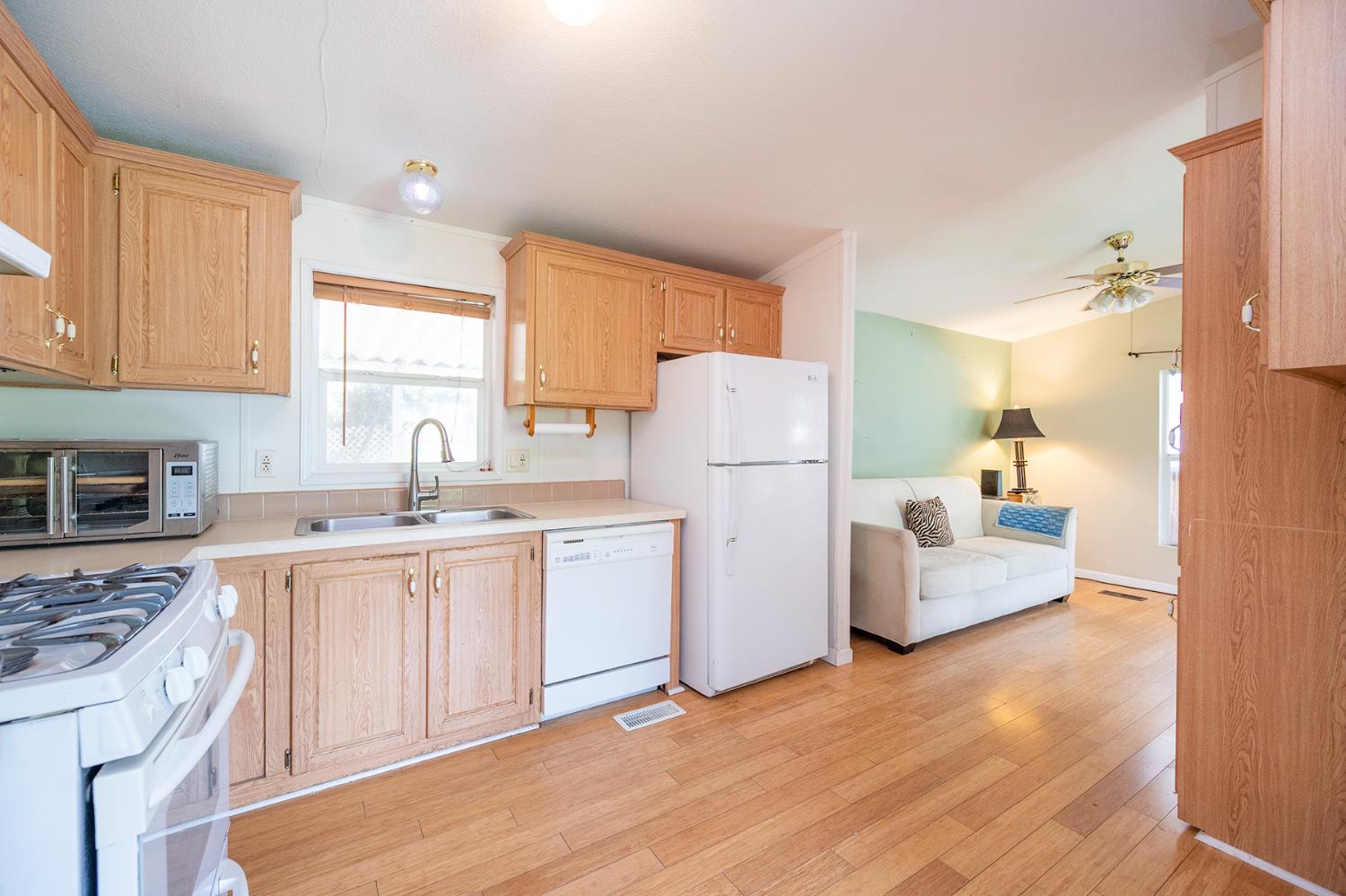 132 Danielle Way Folsom, CA 95630 - Photo 25 of 52 a kitchen with a sink a refrigerator and cabinets