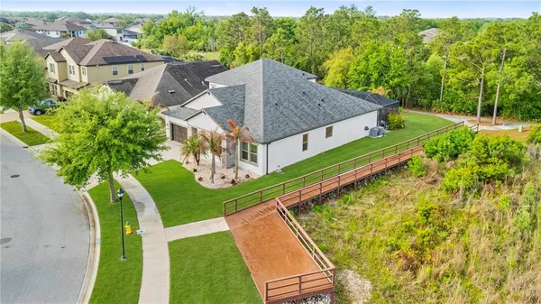 an aerial view of a house with a swimming pool