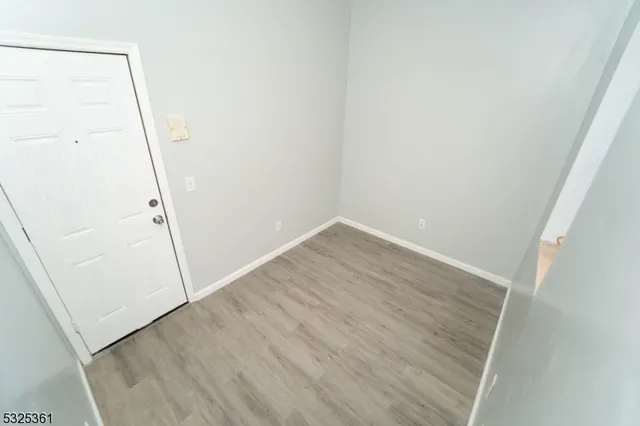 a view of entryway with stairs and wooden floor