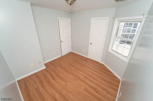 a view of a room with wooden floor and window