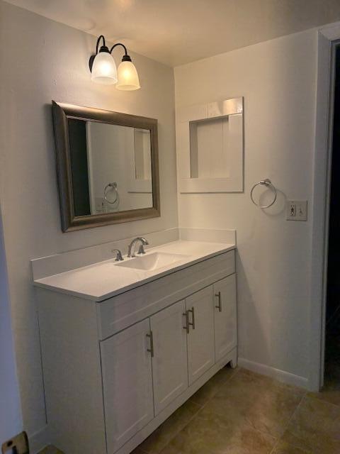 21938 Remsen Terrace, Unit 209 Boca Raton, FL 33433 - Photo 12 of 20 a bathroom with a double vanity sink and a mirror