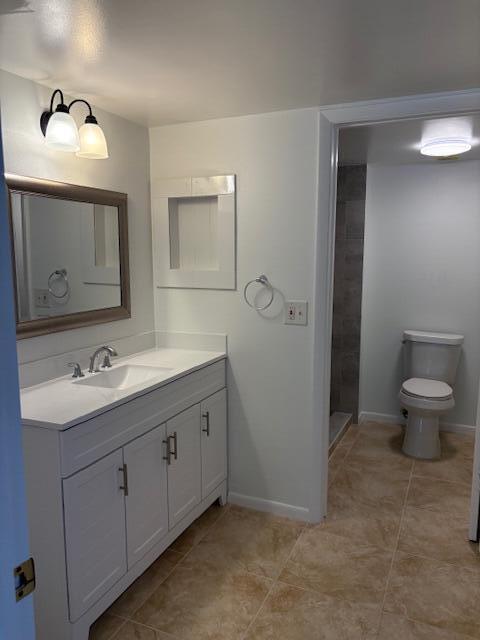 21938 Remsen Terrace, Unit 209 Boca Raton, FL 33433 - Photo 13 of 20 a bathroom with a toilet sink and mirror