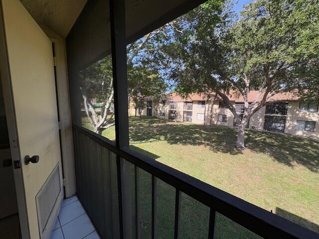 21938 Remsen Terrace, Unit 209 Boca Raton, FL 33433 - Photo 18 of 20 a view of a wooden deck next to a yard