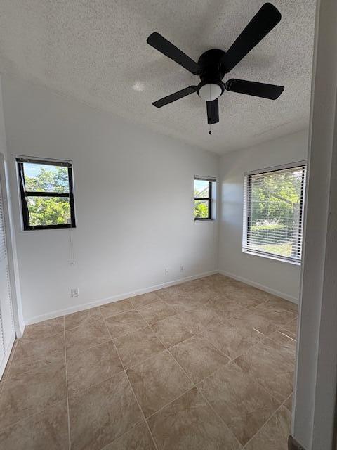 21938 Remsen Terrace, Unit 209 Boca Raton, FL 33433 - Photo 6 of 20 an empty room with windows and ceiling fan