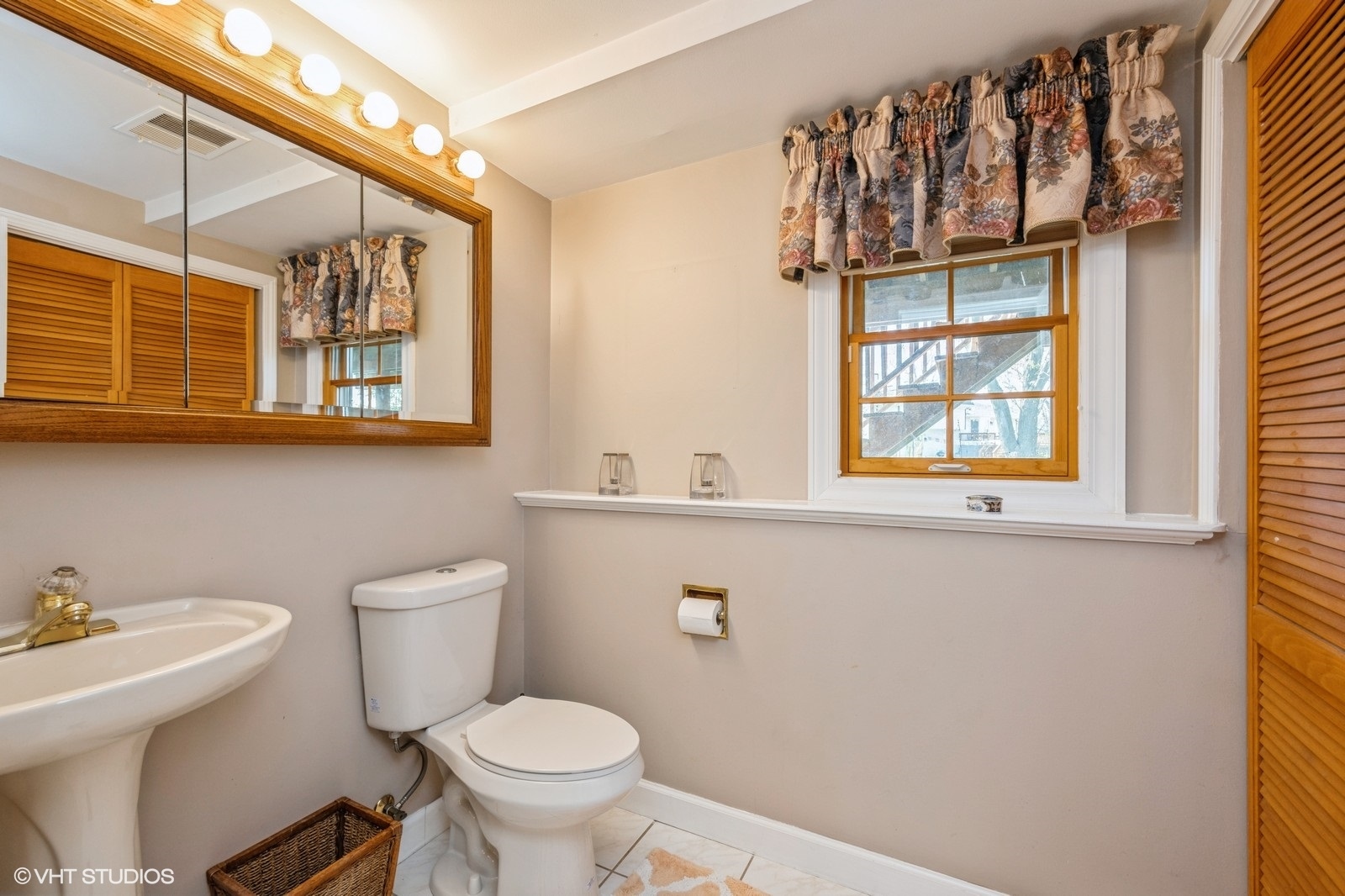 4130 North Firestone Drive Hoffman Estates, IL 60192 - Photo 20 of 27 a bathroom with a toilet a sink and a window