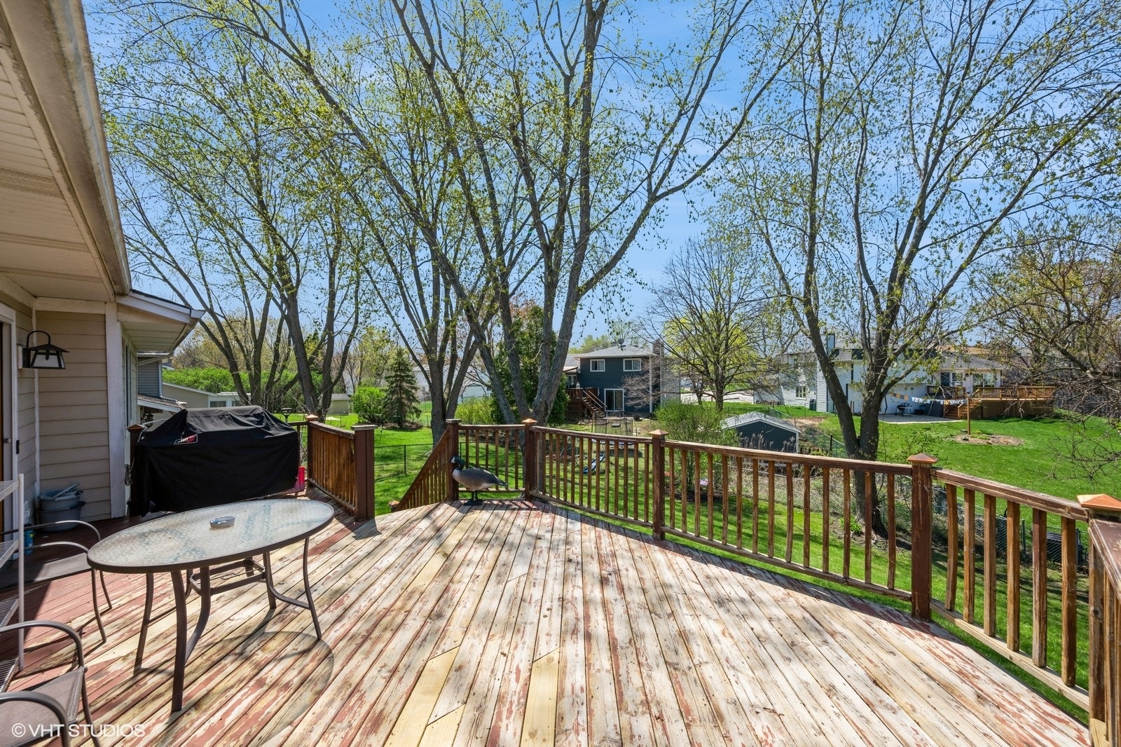 4130 North Firestone Drive Hoffman Estates, IL 60192 - Photo 21 of 27 a view of a deck with a table and chairs next to a yard