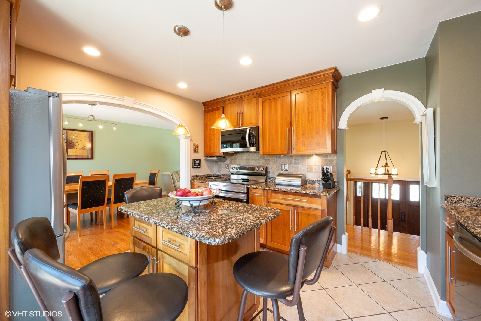4130 North Firestone Drive Hoffman Estates, IL 60192 - Photo 8 of 27 a kitchen with stainless steel appliances granite countertop a stove a sink a dining table and chairs