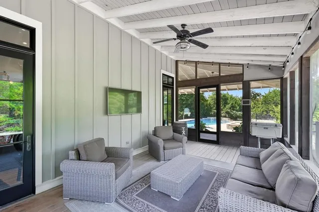 a living room with furniture and a floor to ceiling window