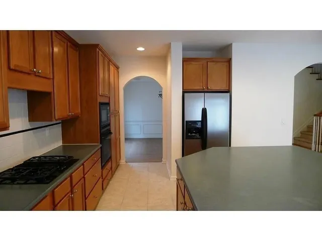 a kitchen with a wooden floor and a stove top oven