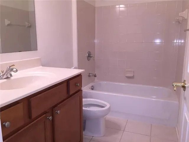 a bathroom with a sink a toilet and a bathtub