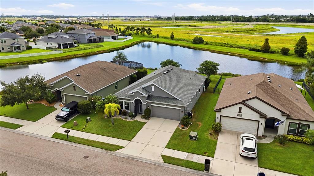 10920 79th Street East Parrish, FL 34219 - Photo 56 of 73 an aerial view of a house with a garden and lake view