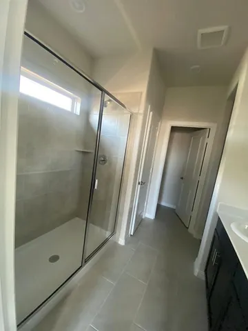 a bathroom with a glass shower door