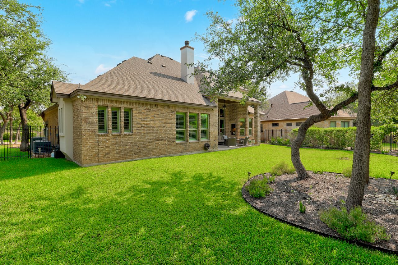 809 Prairie Dunes Drive Georgetown, TX 78628 - Photo 39 of 40 A verdant lawn frames the brick structure, creating an idyllic outdoor space for leisure and entertainment.