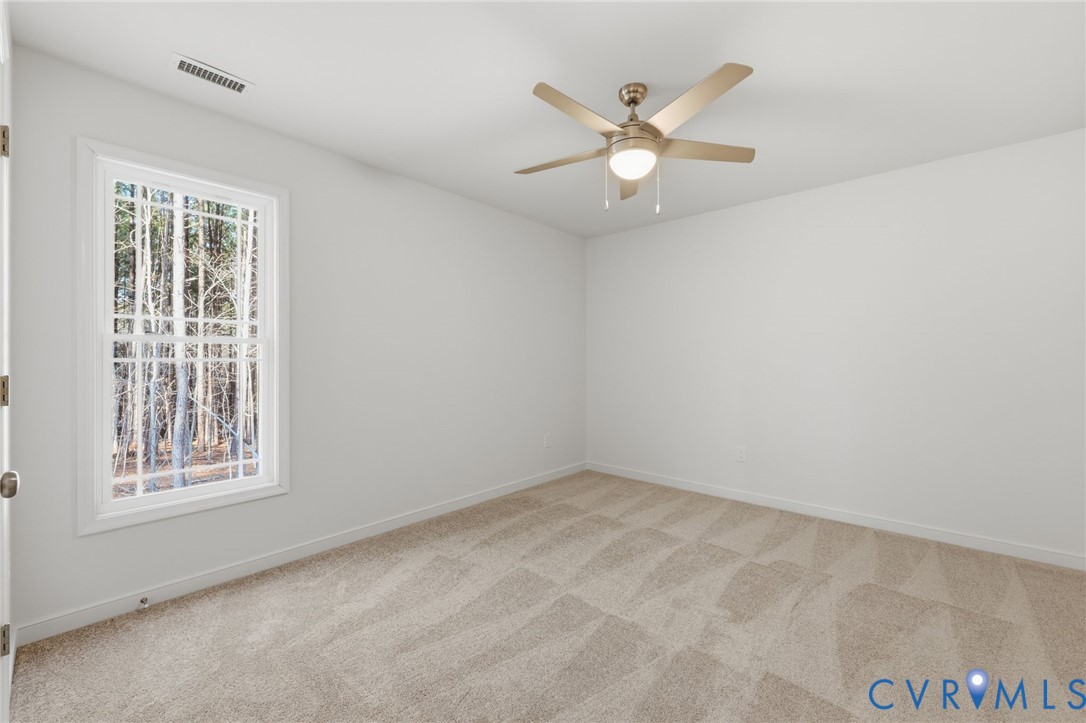 2460 Ballsville Road Powhatan, VA 23139 - Photo 16 of 28 an empty room with windows and fan