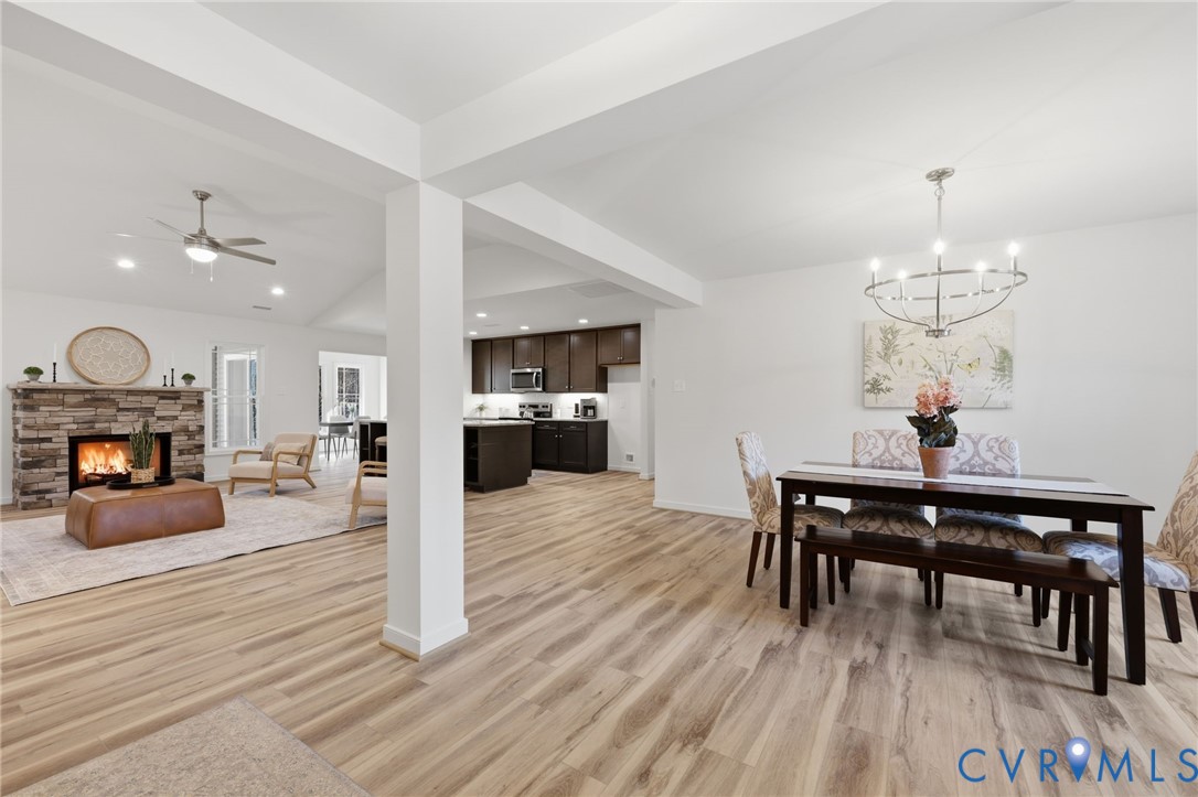 2460 Ballsville Road Powhatan, VA 23139 - Photo 3 of 28 a view of a dining room and a livingroom with furniture wooden floor a chandelier