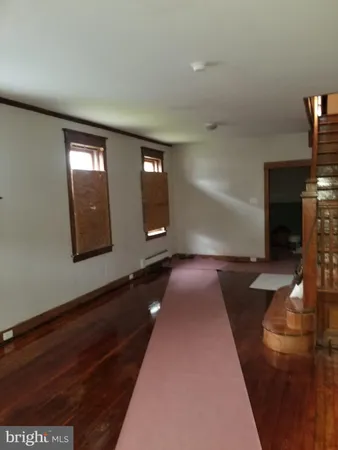 wooden floor in a hall with a window