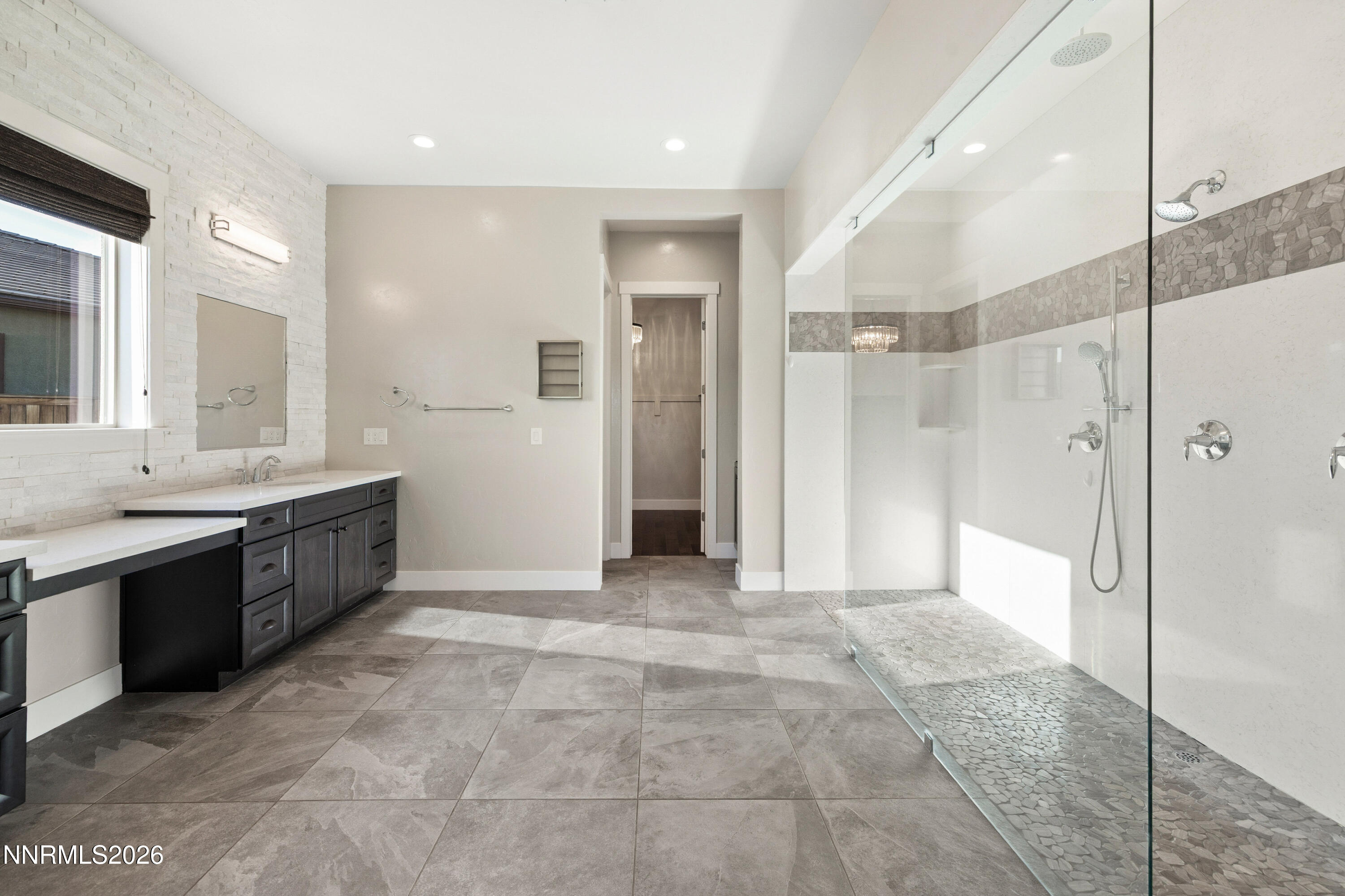 2223 Hillsborough Street Reno, NV 89523 - Photo 21 of 41 a large bathroom with a glass shower door a sink and a bathtub