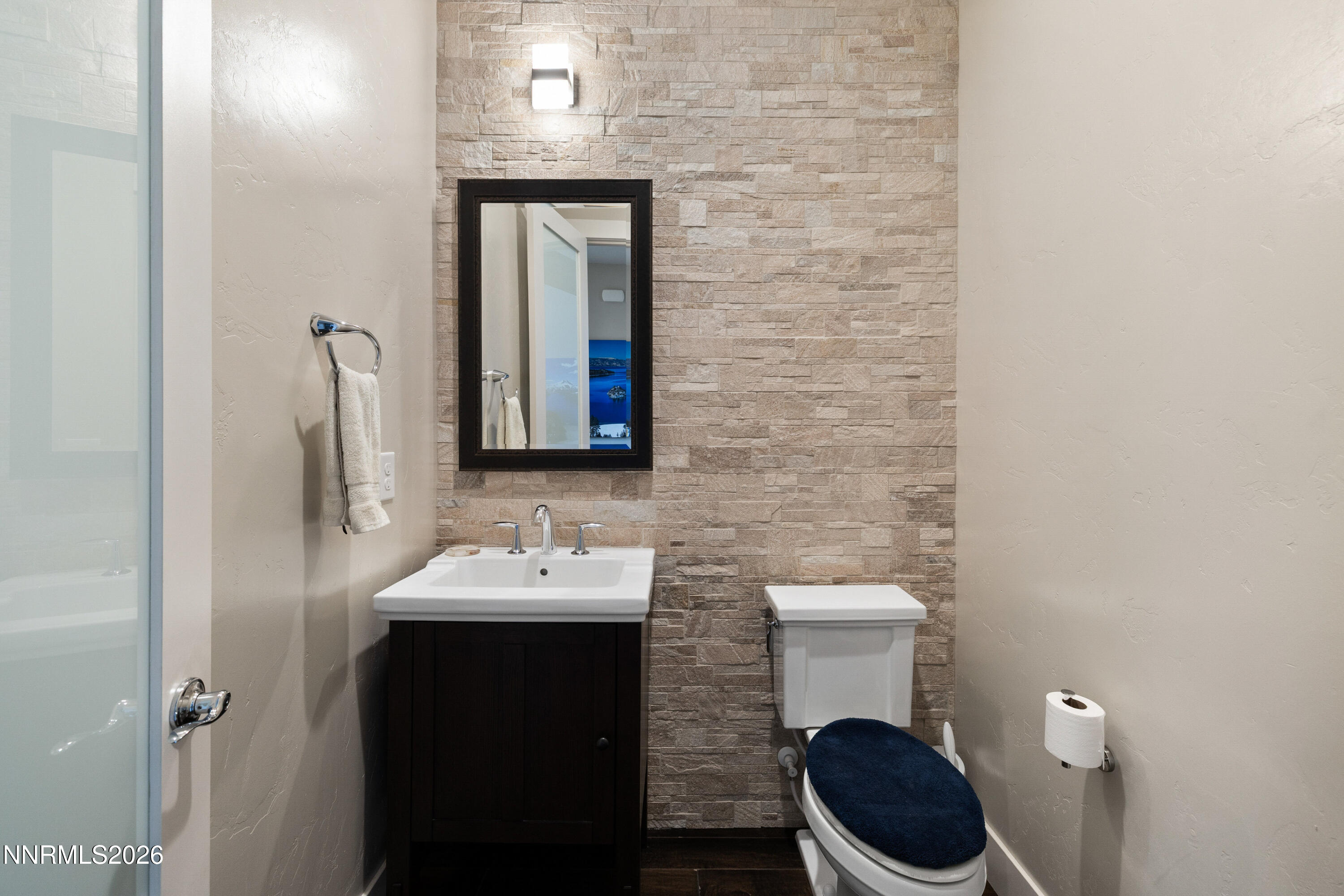 2223 Hillsborough Street Reno, NV 89523 - Photo 28 of 41 a bathroom with a toilet a sink and mirror