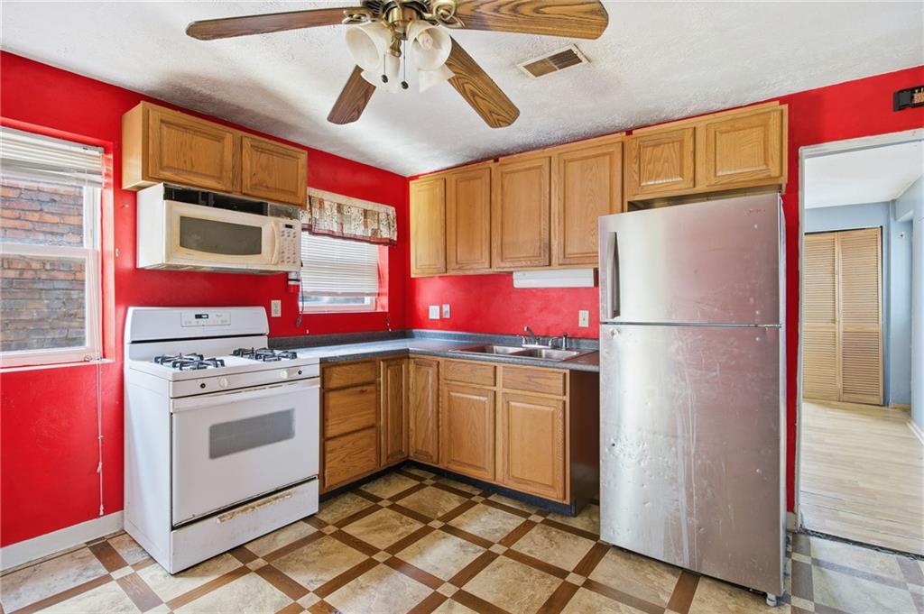 1450 Fleming Avenue McKees Rocks, PA 15136 - Photo 16 of 29 a kitchen with stainless steel appliances granite countertop a refrigerator and a stove top oven