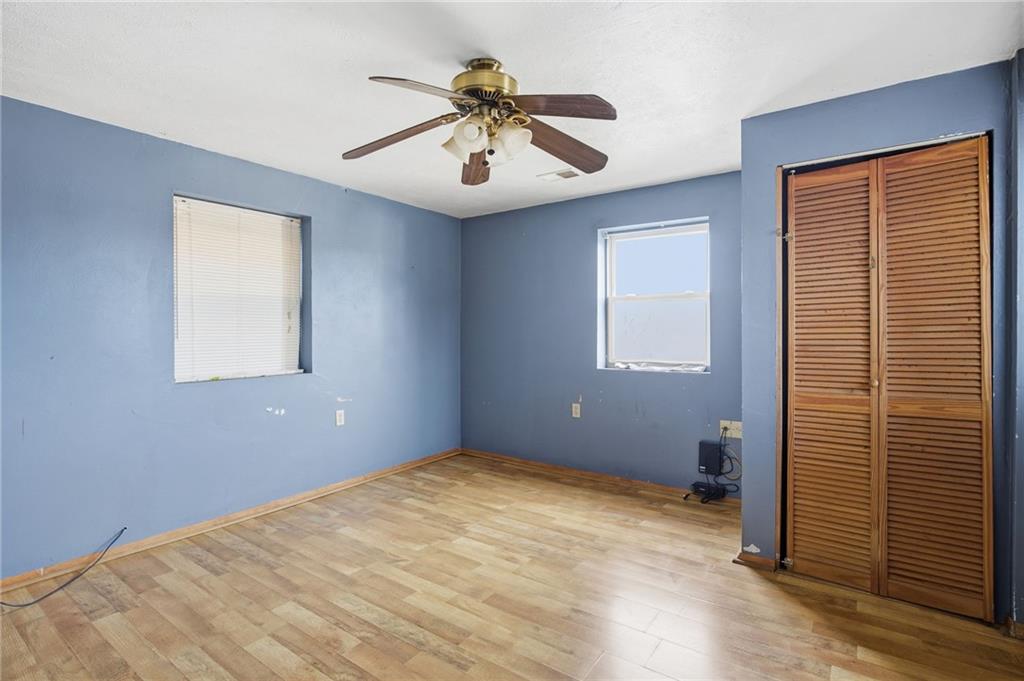 1450 Fleming Avenue McKees Rocks, PA 15136 - Photo 19 of 29 an empty room with ceiling fan and windows