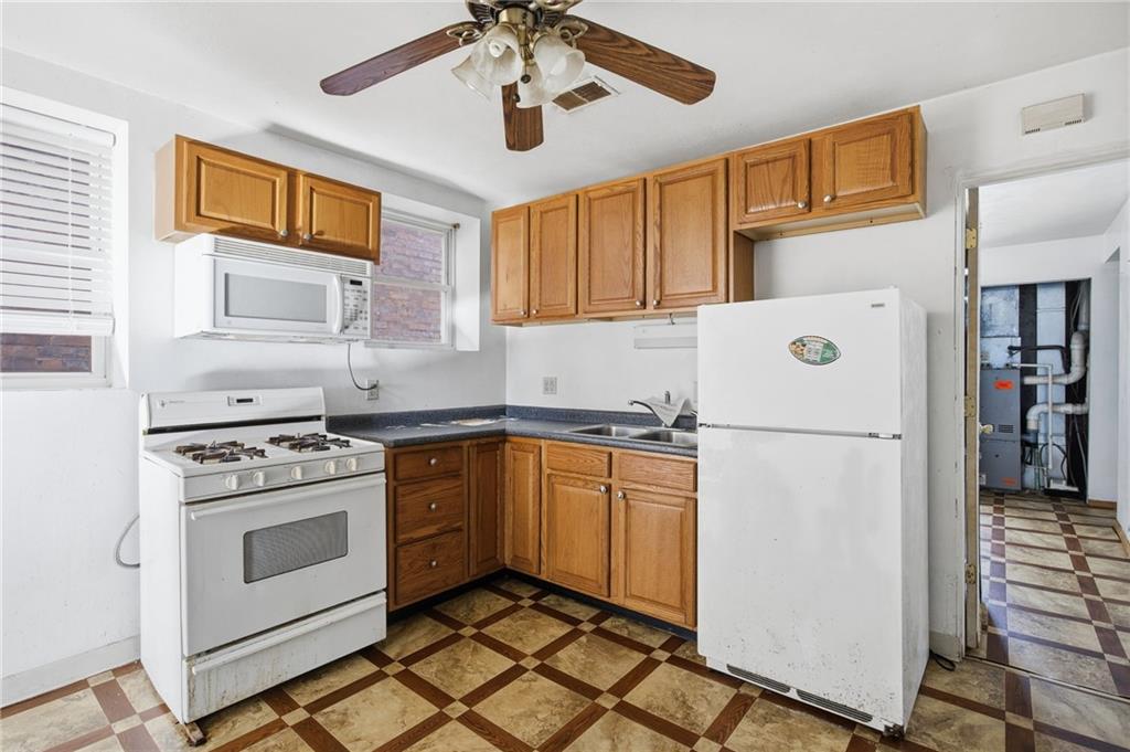 1450 Fleming Avenue McKees Rocks, PA 15136 - Photo 5 of 29 a kitchen with a refrigerator a stove cabinets projector and a dining table