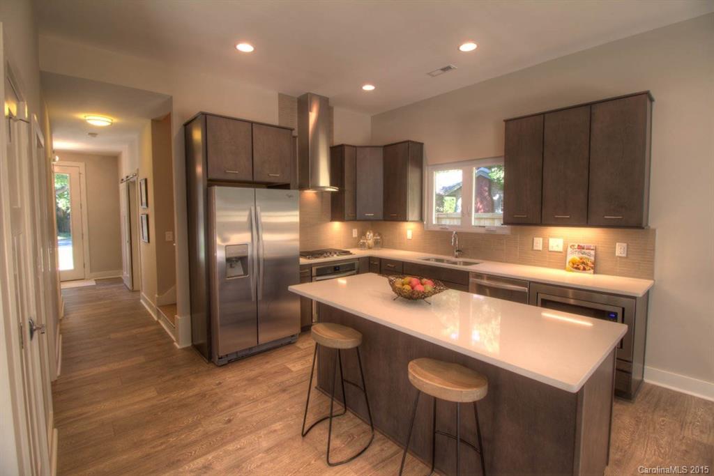 1632 Longfellow Street Charlotte, NC 28205 - Photo 2 of 24 a kitchen with a refrigerator a sink and a microwave