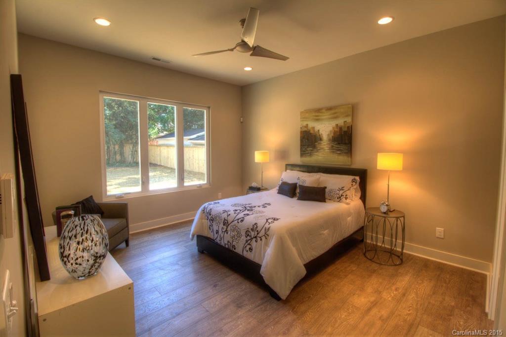 1632 Longfellow Street Charlotte, NC 28205 - Photo 11 of 24 a bedroom with a bed couch and window