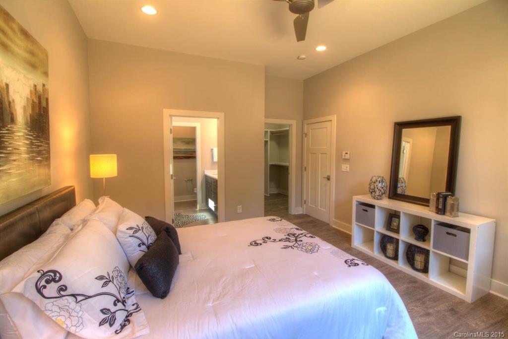 1632 Longfellow Street Charlotte, NC 28205 - Photo 12 of 24 a bedroom with a large bed and a dresser