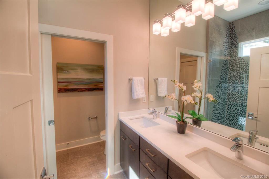 1632 Longfellow Street Charlotte, NC 28205 - Photo 14 of 24 a bathroom with a sink and a mirror