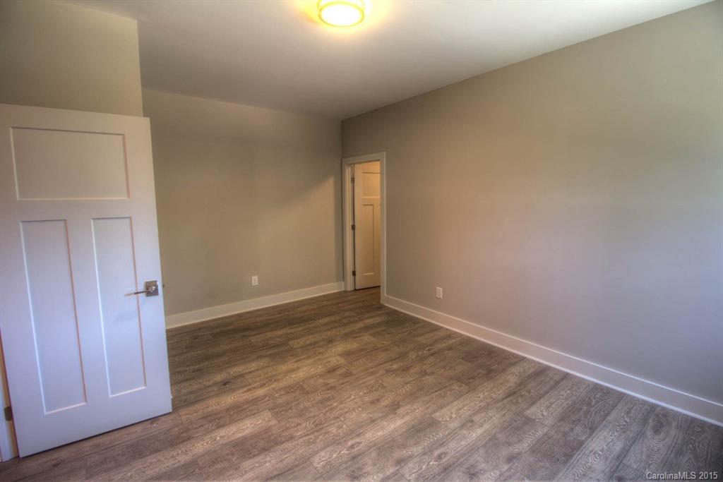 1632 Longfellow Street Charlotte, NC 28205 - Photo 20 of 24 an empty room with wooden floor and windows