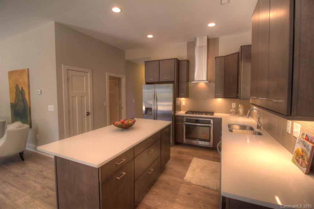 1632 Longfellow Street Charlotte, NC 28205 - Photo 3 of 24 a kitchen with a sink and a stove top oven