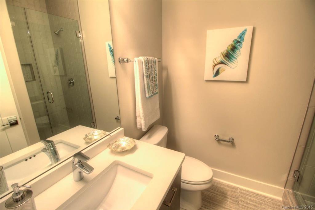 1632 Longfellow Street Charlotte, NC 28205 - Photo 21 of 24 a bathroom with a granite countertop sink and a mirror