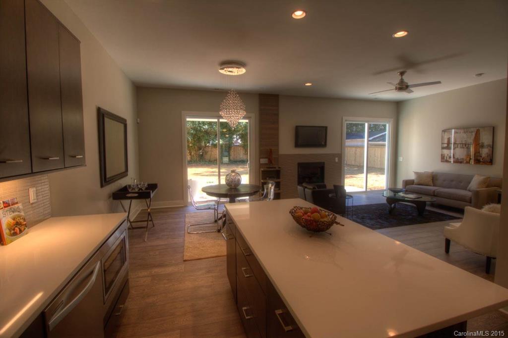 1632 Longfellow Street Charlotte, NC 28205 - Photo 4 of 24 a large kitchen with sink a refrigerator and a stove top oven