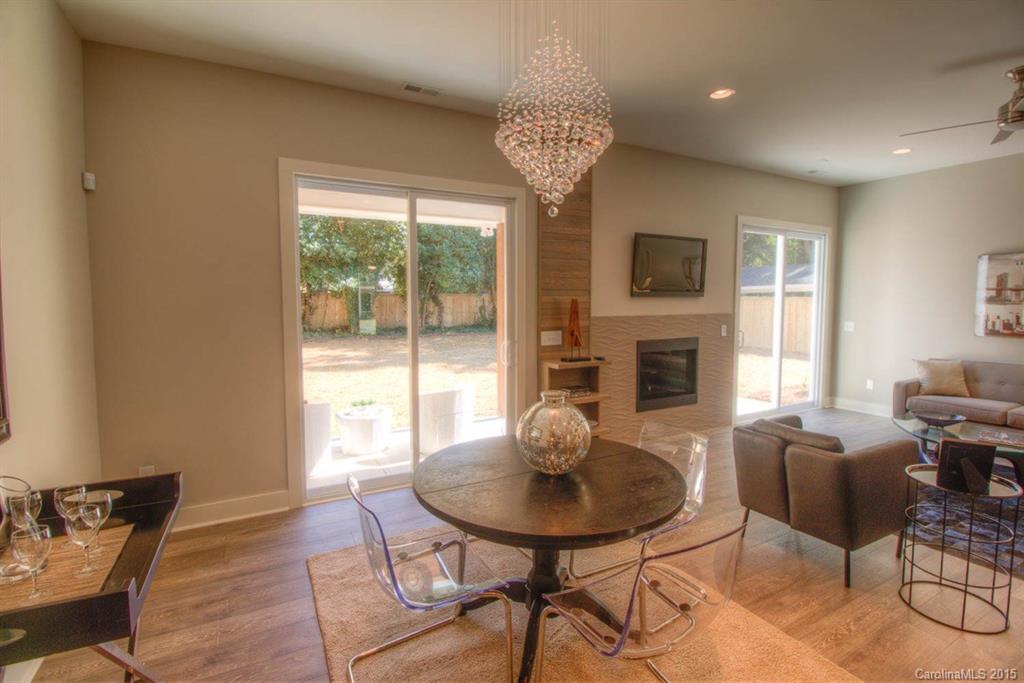 1632 Longfellow Street Charlotte, NC 28205 - Photo 5 of 24 a living room with furniture a fireplace and a large window