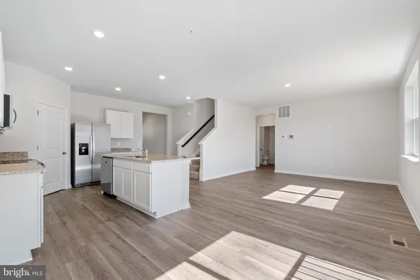 a view of kitchen with cabinets and wooden floor