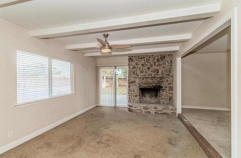 5662 North McCall Avenue Clovis, CA 93619 - Photo 5 of 34 a view of an empty room with a fireplace and a window