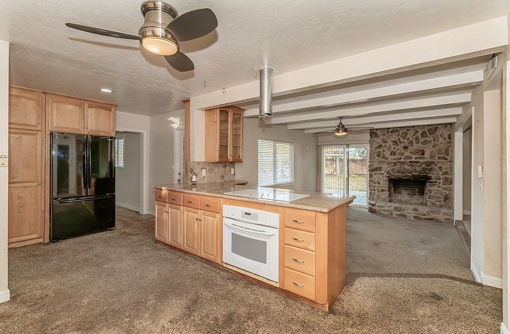 5662 North McCall Avenue Clovis, CA 93619 - Photo 8 of 34 a kitchen with stainless steel appliances granite countertop a stove and a refrigerator