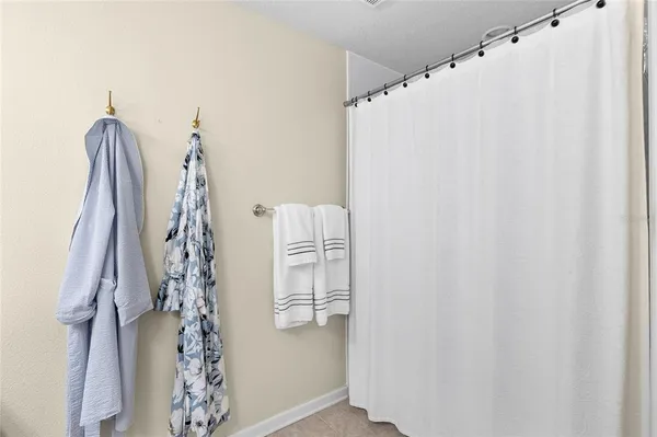 a bedroom with a large bed and a flat tv screen on a dresser