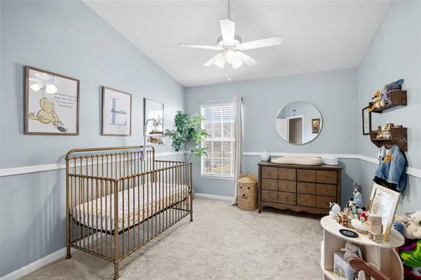 a kitchen with white cabinets and chairs