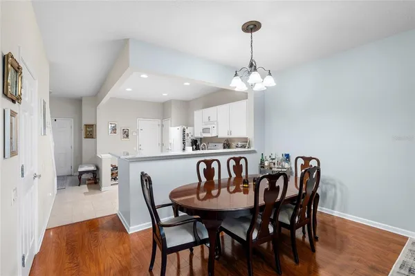 a view of a dining room with furniture wooden floor and chandelier