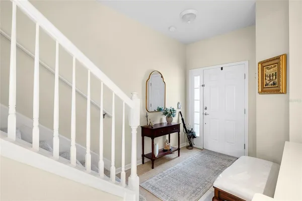 a front view of a house with yard and parking