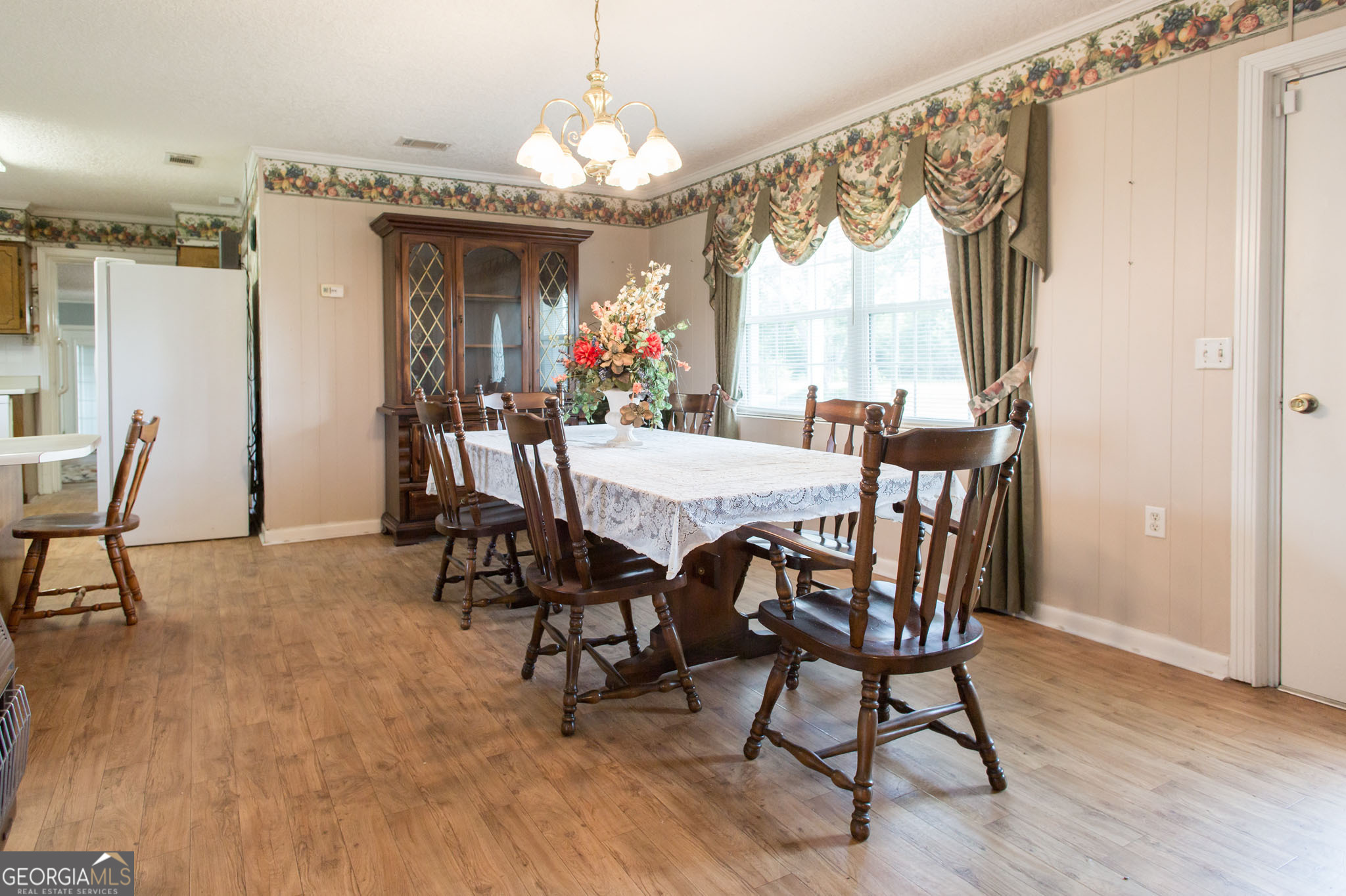 596 Teakwood Road Alma, GA 31510 - Photo 12 of 54 a view of a dining room with furniture window and wooden floor