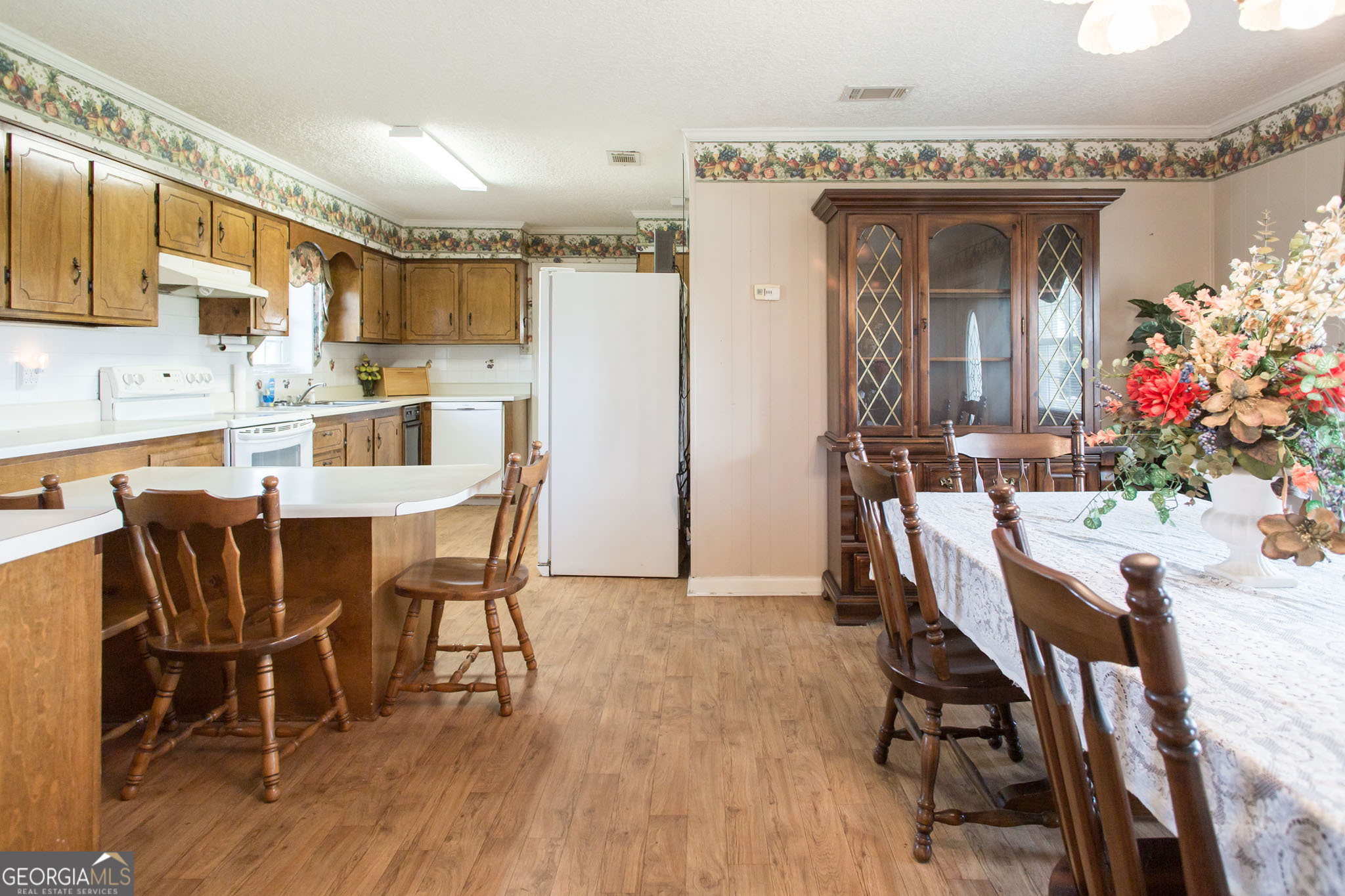 596 Teakwood Road Alma, GA 31510 - Photo 13 of 54 a view of a dining room with furniture and wooden floor