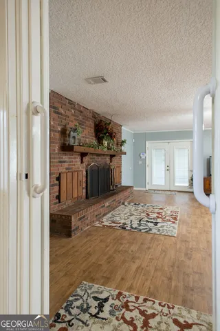 a view of a dining room with furniture a chandelier and wooden floor