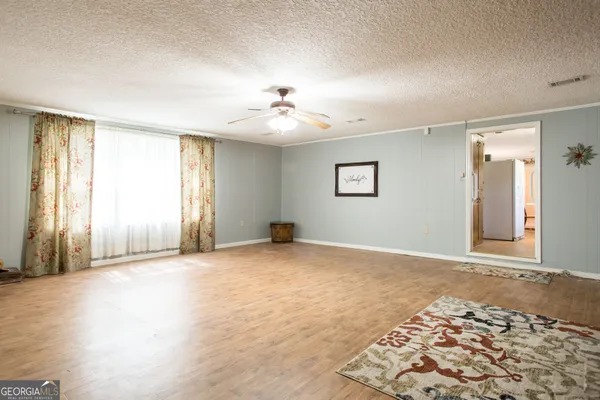 a view of a livingroom with furniture and a flat screen tv