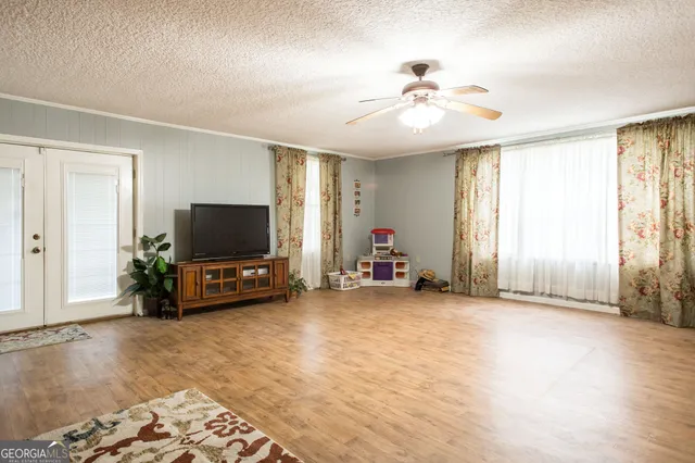 a view of a livingroom with wooden floor and a window