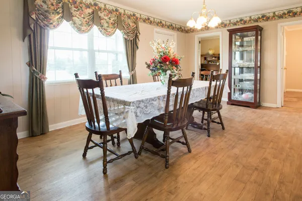 a view of a dining room with furniture and a chandelier