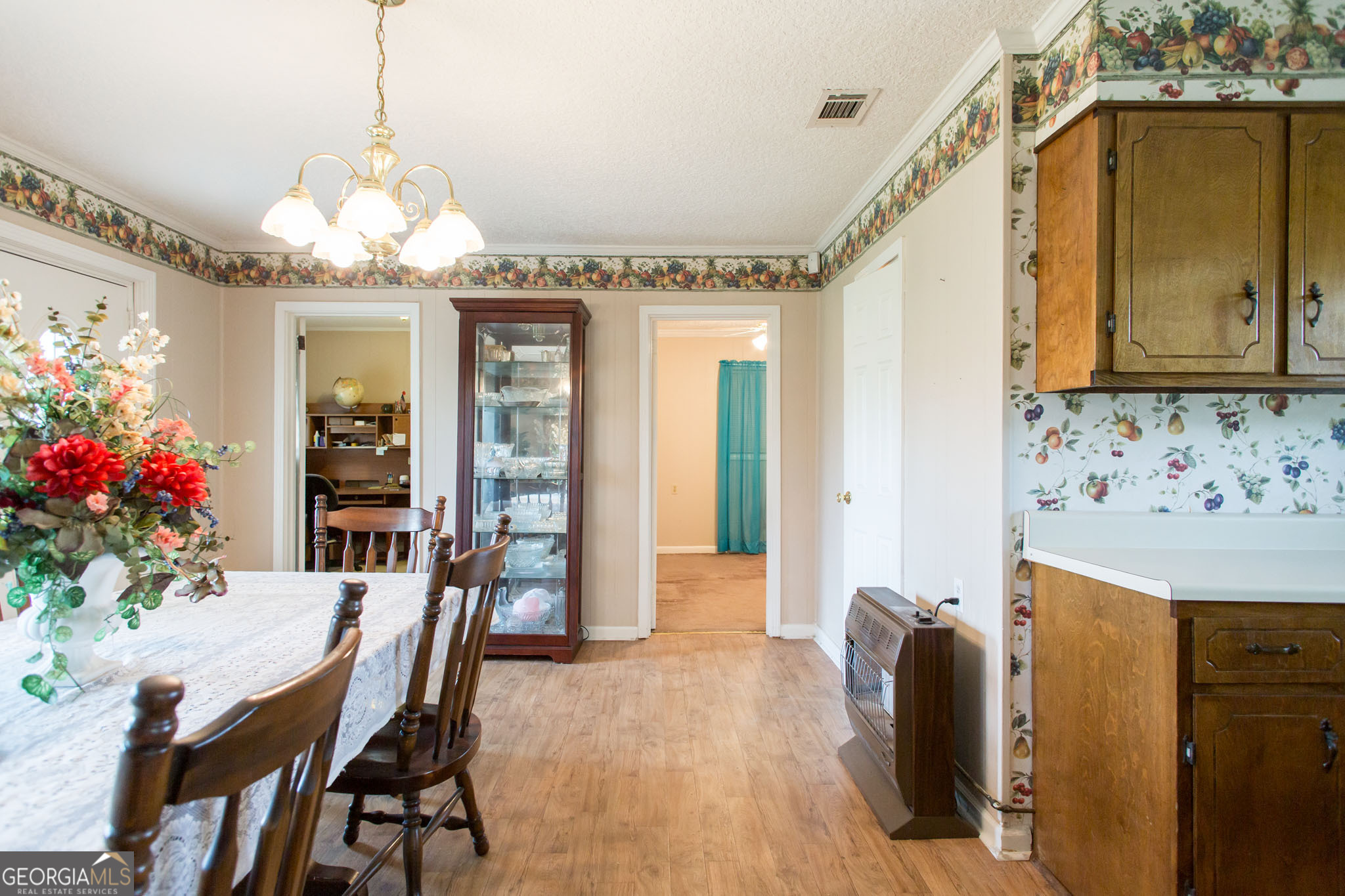 596 Teakwood Road Alma, GA 31510 - Photo 26 of 54 a view of a dining room with furniture and a chandelier