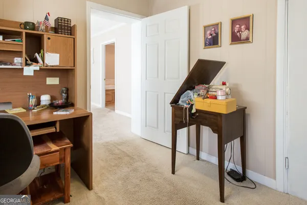an empty room with closet and a ceiling fan