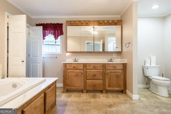 a spacious bathroom with a sink double vanity and granite